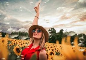 Rising Mortgage Rates, Woman pointing up, Sunflowers, Bubbles, interest Rates